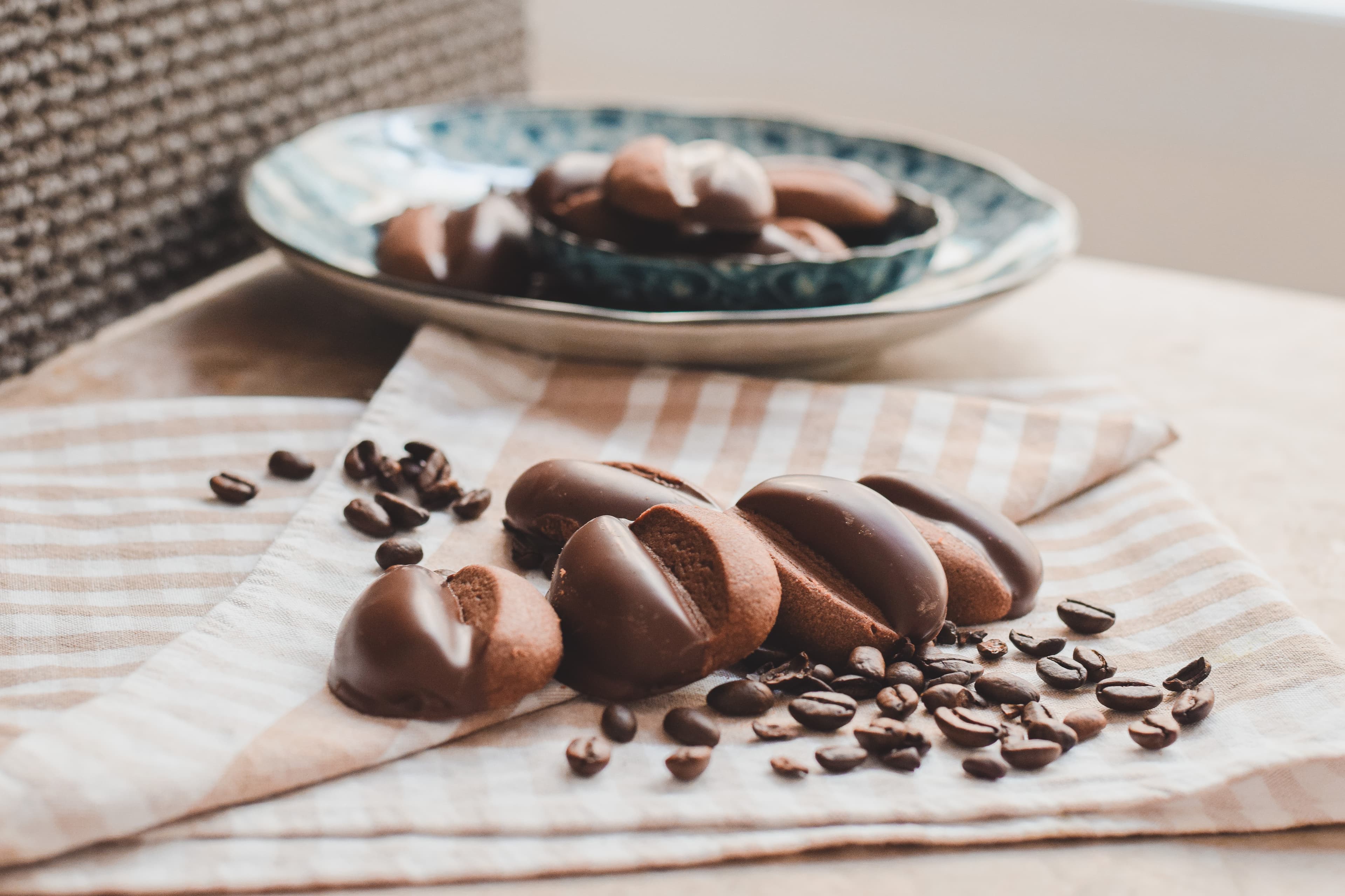 Coffee cookies on a striped cloth with a plate in the background
